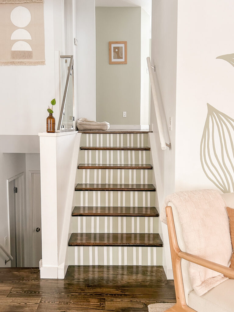 Striped Painted Stairs Mural Tutorial of painted stair risers that are so cheap and easy to do in your home.