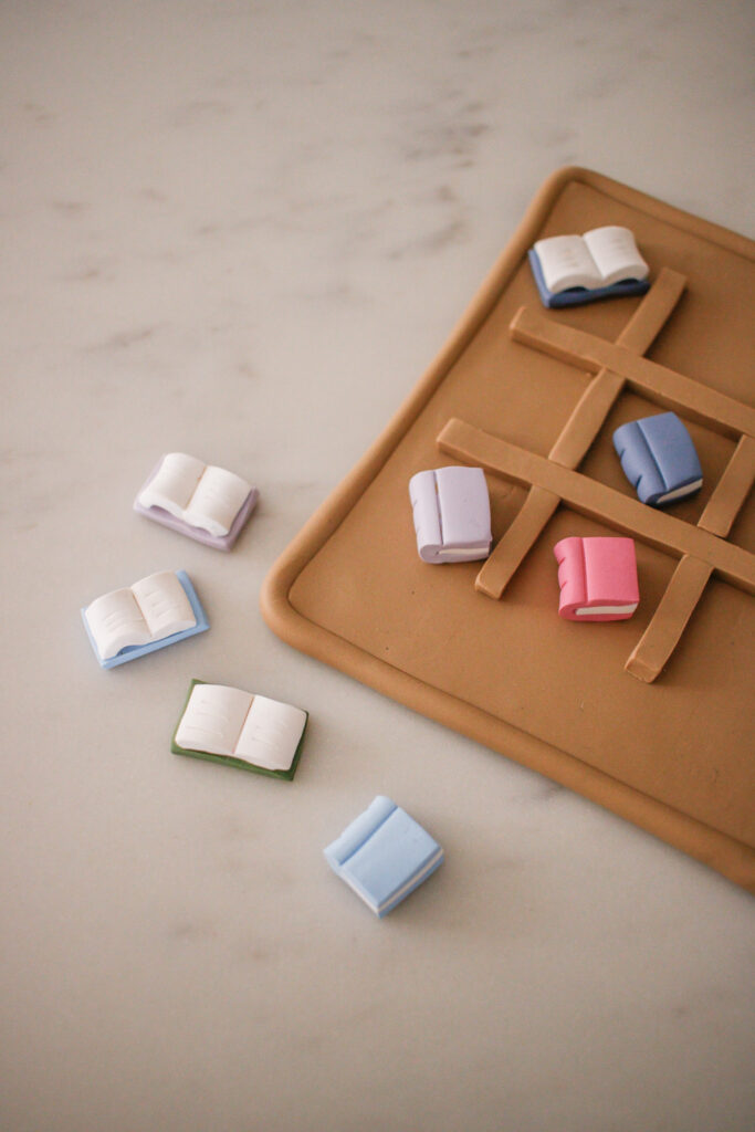 DIY Clay Book Tic Tac Toe Game made of oven bake clay. A table-top game for book lovers. The perfect easy DIY for girls night.